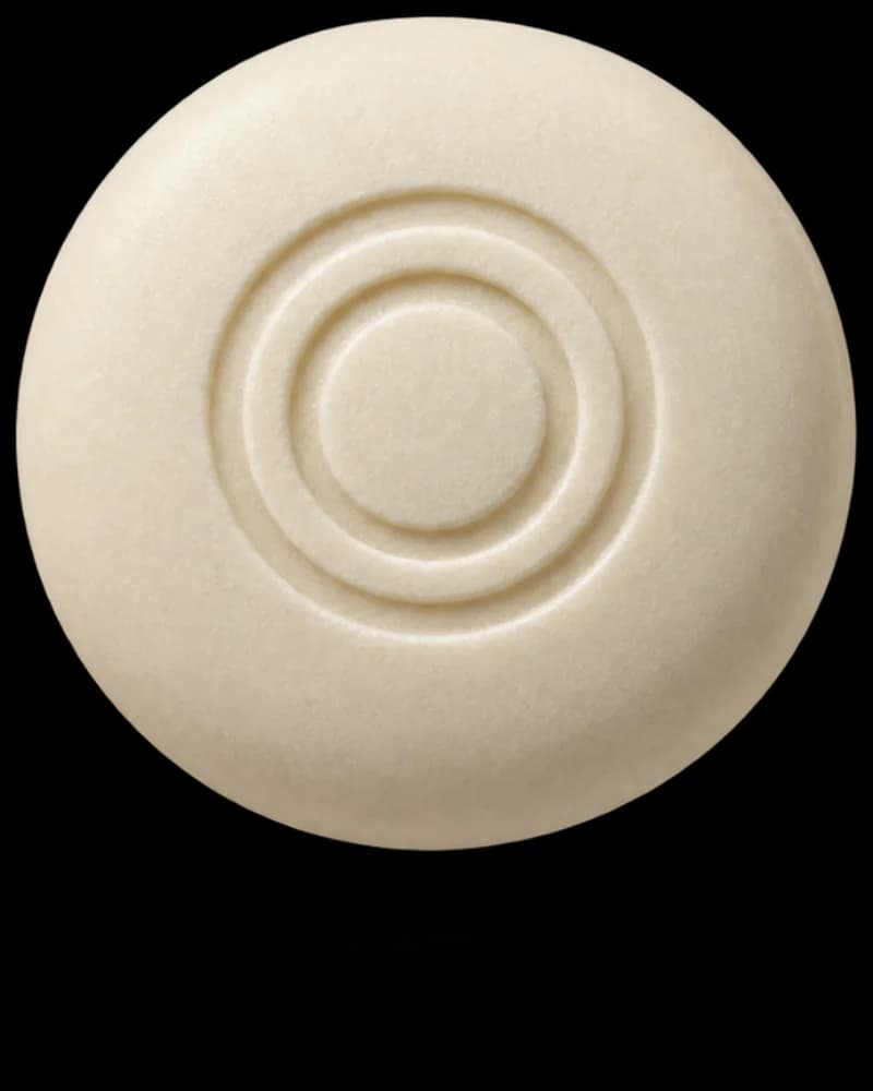 Illustrative cream-colored ONEORAL mint with an embossed two-ring logo and a soft floating shadow