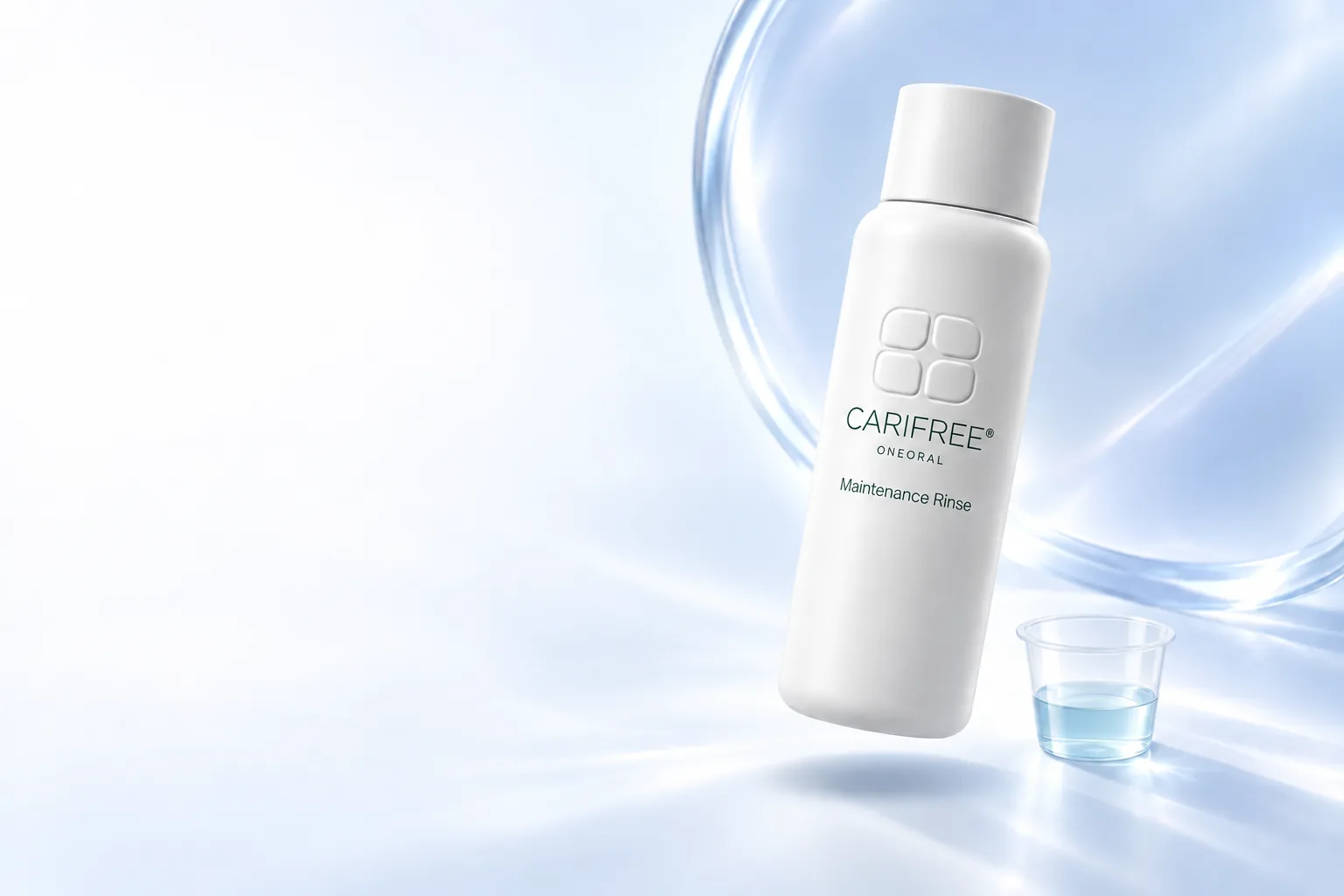 White CariFree-branded Maintenance Rinse bottle with small ONEORAL wordmark beside a clear rinse cup in ice-blue light