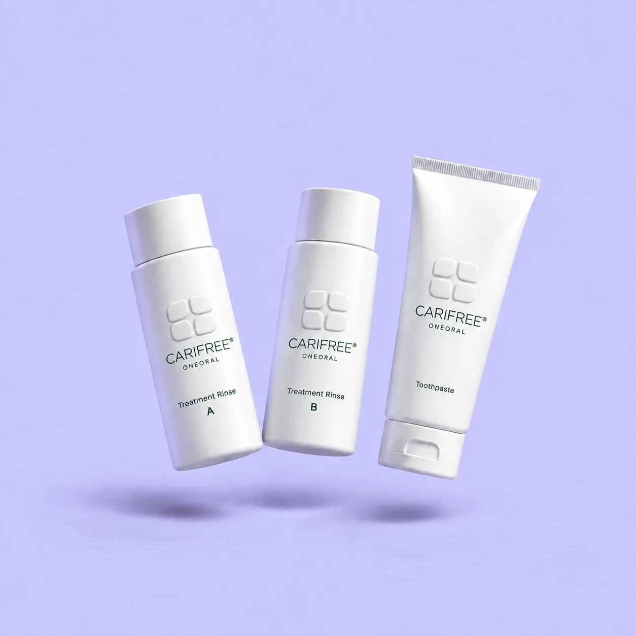 White CariFree-branded Treatment Rinse bottles and toothpaste with small ONEORAL wordmarks floating against lavender