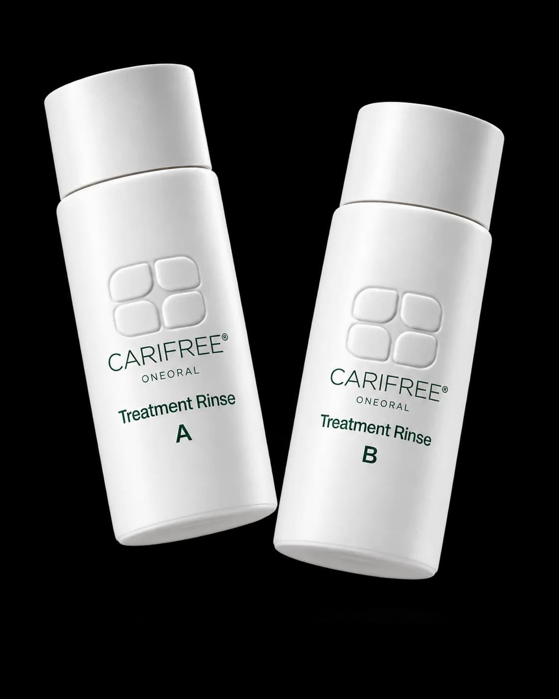 White Treatment Rinse A and B bottles with embossed CariFree logos and small ONEORAL wordmarks