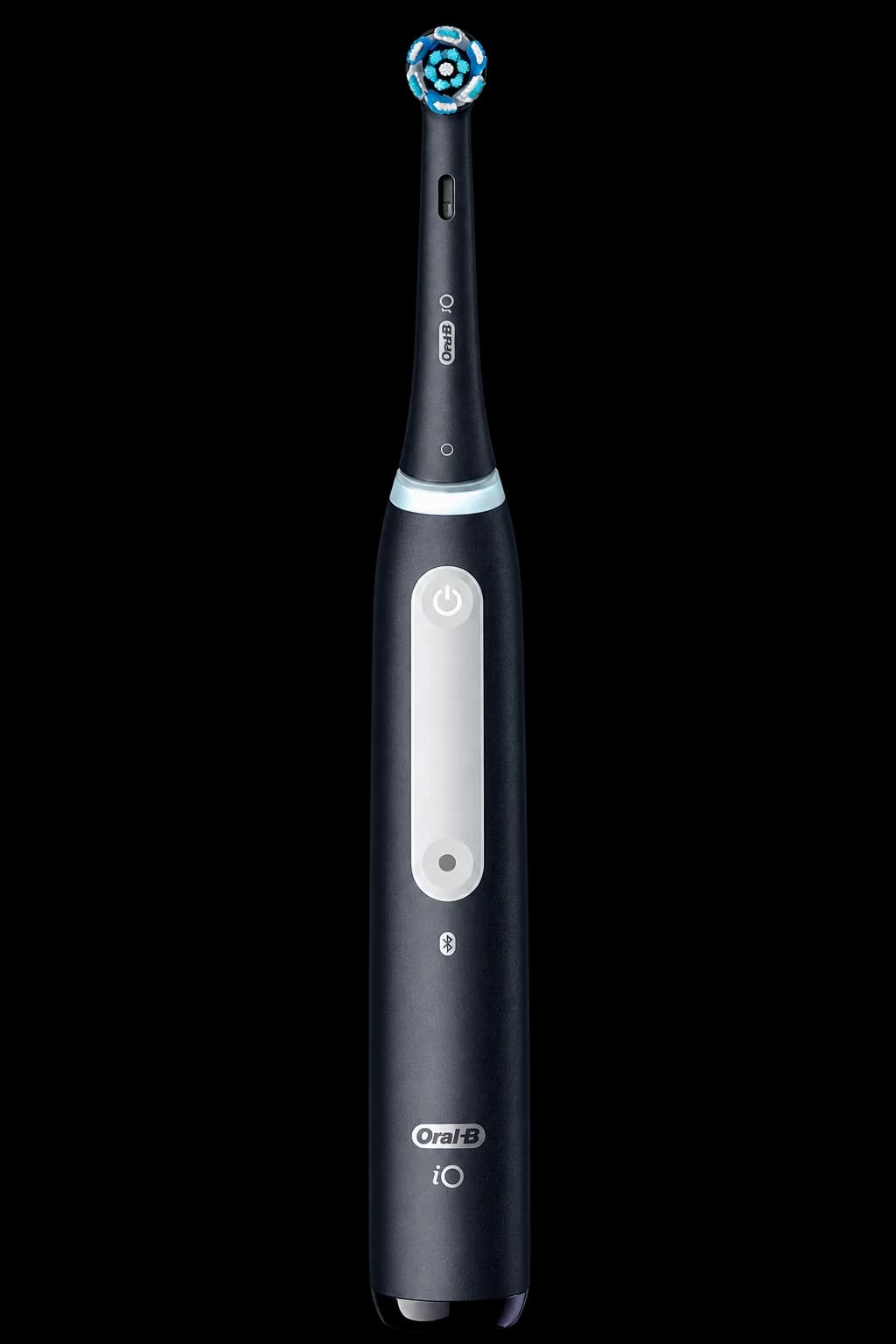 Photo-style black electric toothbrush with a small round brush head and white power-button panel