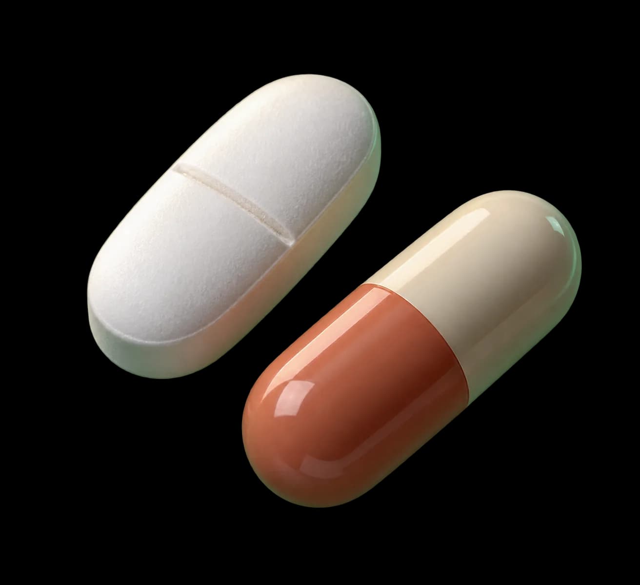 Illustrative generic white scored oval tablet beside an ivory and terracotta capsule