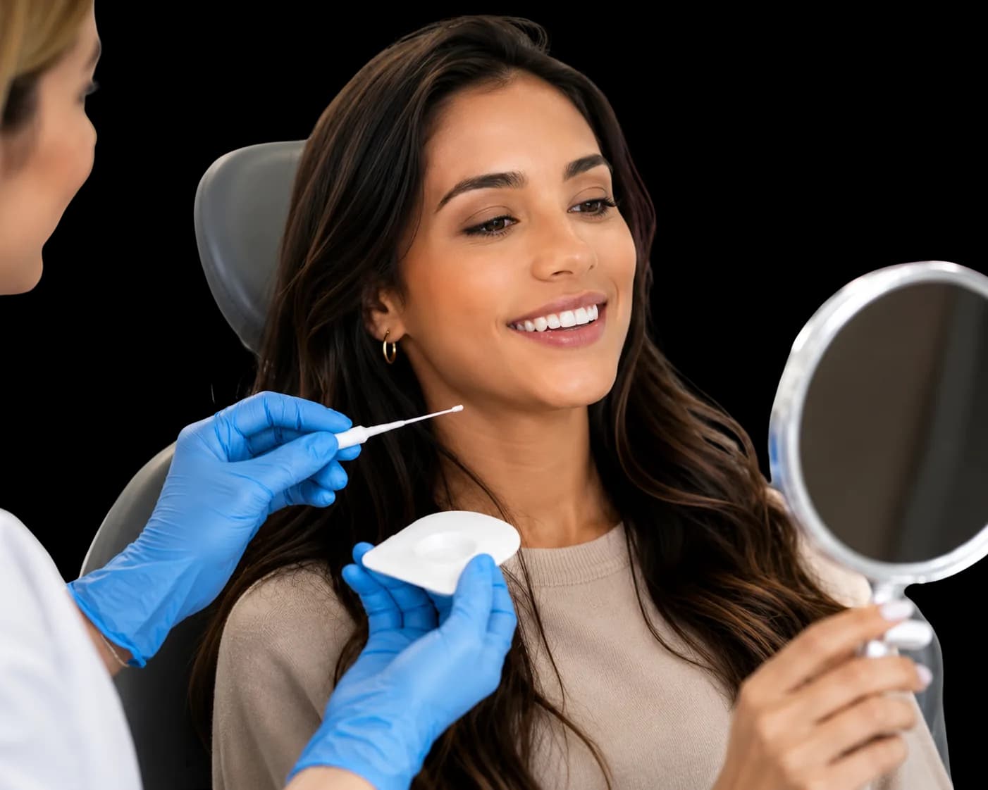 A dentist holding a treatment applicator beside a patient who is looking in a mirror