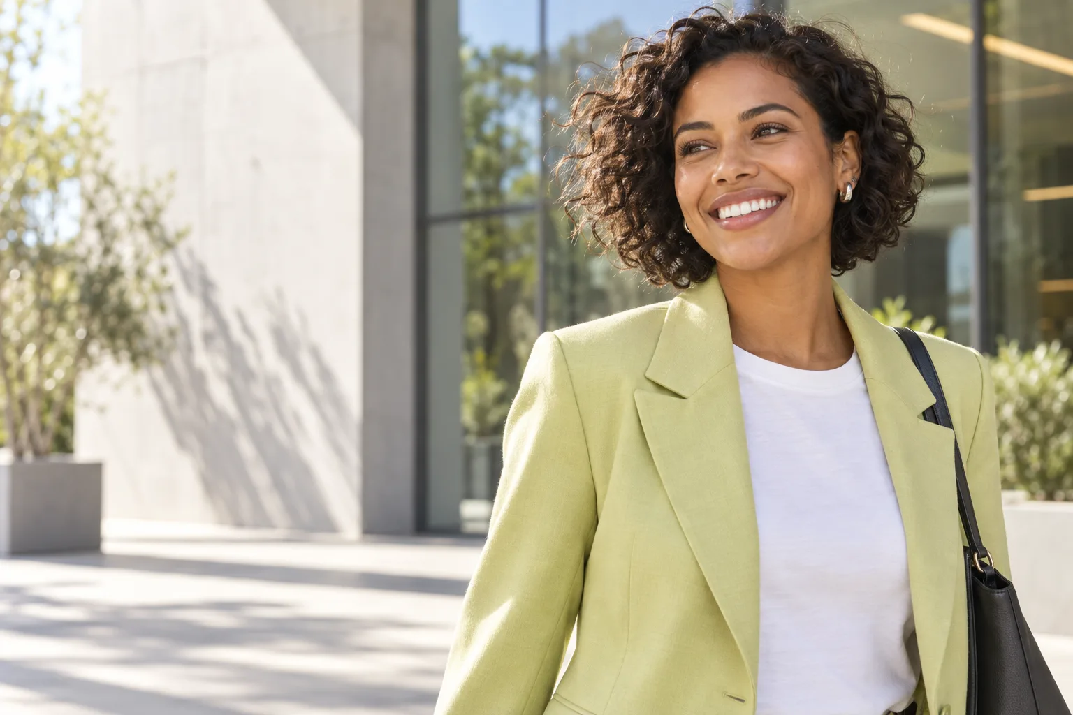 Smiling woman in a chartreuse jacket during her workday