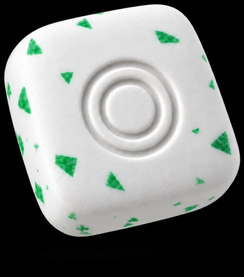 Illustrative white ONEORAL energy gum piece with green flecks and an embossed two-ring logo