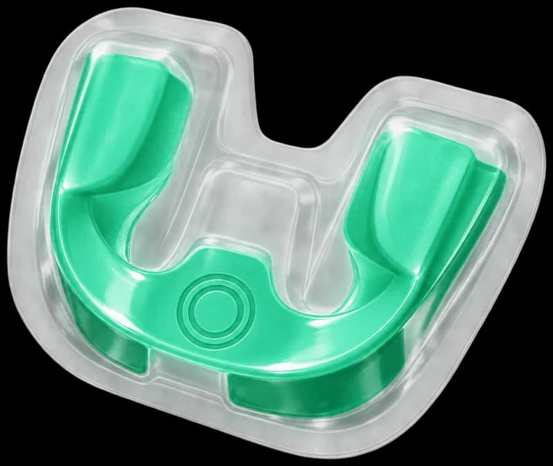 Illustrative ONEORAL whitening tray with a clear outer tray and green inner tray