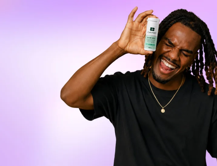 A OneOral member holding a tin of xylitol breath mints