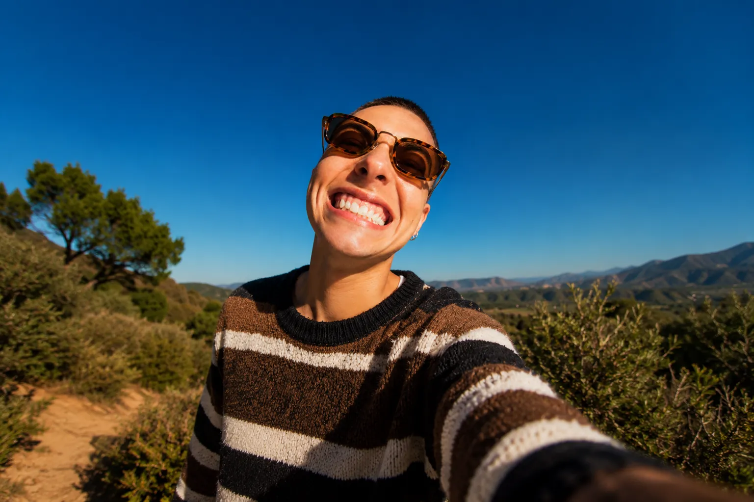 A OneOral member outdoors, laughing